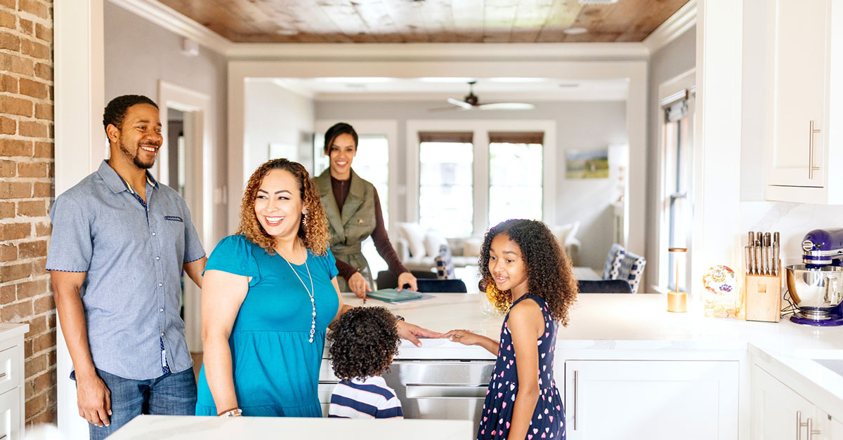 An agent showing a home to a young family