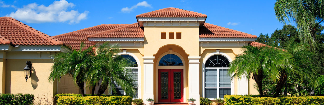 Yellow home exterior with palm trees