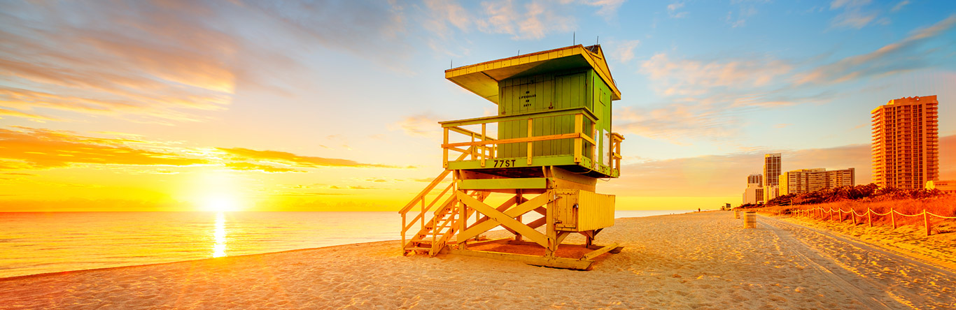 Lifeguard hut on beach at sunrise